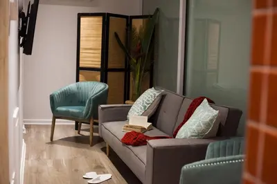 a living room with a couch and a chair at Mister C in Hartbeespoort