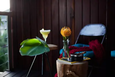 a table with a vase with a flower in it at Mister C in Hartbeespoort