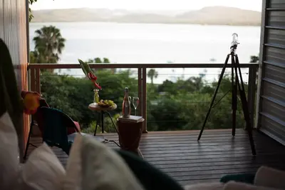 a view of the water from a balcony with a camera at Mister C in Hartbeespoort
