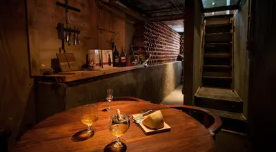 a wooden table with two wine glasses on it at Mister C in Hartbeespoort