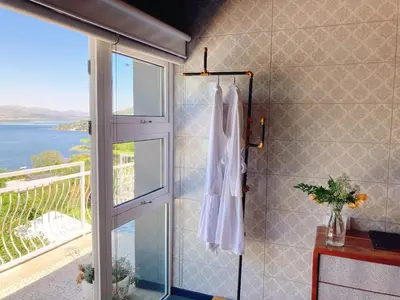 a bathroom with a shower with a view of the ocean at Mister C in Hartbeespoort