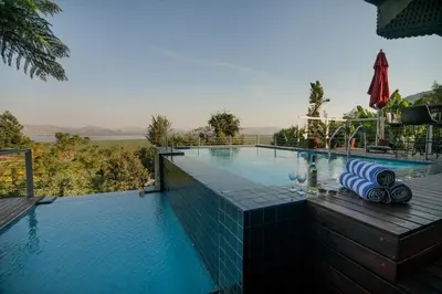 a swimming pool with a view of the water at Mister C in Hartbeespoort