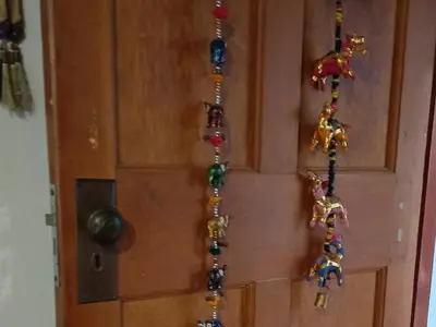 a wooden door with prayer beads on it at Wooden Creek Estate in Kempton Park
