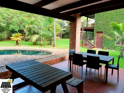 a patio with a table and chairs and a pool at SnL 12 Dwergarend in Malelane