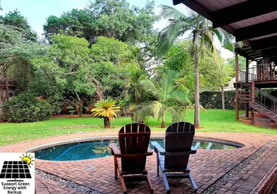 two chairs sitting in front of a swimming pool at SnL 12 Dwergarend in Malelane