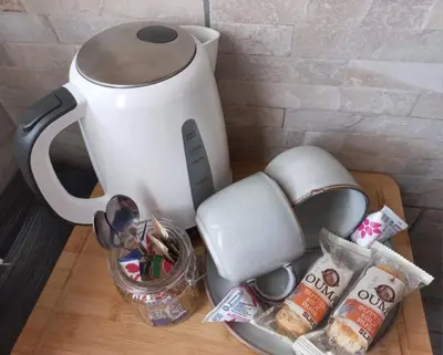 a tea kettle on a wooden table with food at SnL 12 Dwergarend in Malelane