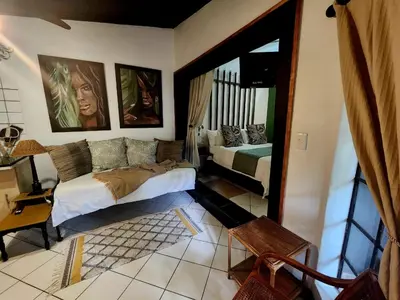a bedroom with two beds and a window in it at Hello Sunshine Self Catering Studio Apartments in Nelspruit