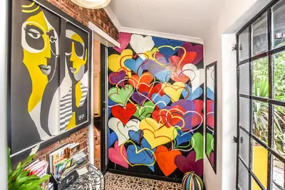 a room with two large paintings on the walls at Hello Sunshine Self Catering Studio Apartments in Nelspruit