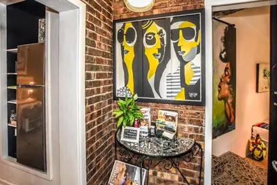 a brick wall with a table in a room at Hello Sunshine Self Catering Studio Apartments in Nelspruit