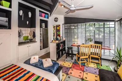 a living room with a couch and a table at Hello Sunshine Self Catering Studio Apartments in Nelspruit