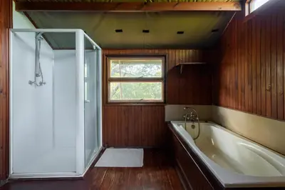 a bathroom with a bath tub and a window at Kelora Bush Camp in Hoedspruit