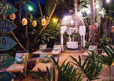 a garden with chairs and a gazebo at night at Club Cocomo in Hartbeespoort