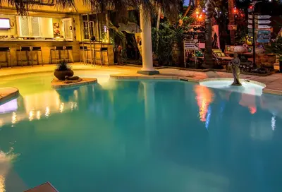 a large blue swimming pool in a building at Club Cocomo in Hartbeespoort