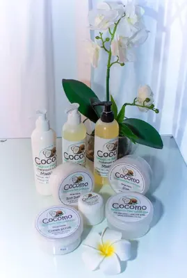 a group of bottles of soap and a vase with flowers at Club Cocomo in Hartbeespoort