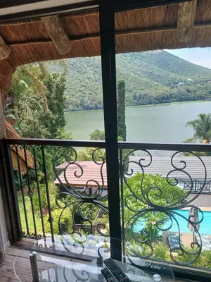 a balcony with a view of a lake at Cozy Kosmos in Hartbeespoort