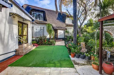 a house with a green lawn in front of it at Lavender Villa No loadshedding in Kempton Park