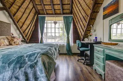 a bedroom with a bed and a desk and window at Lavender Villa No loadshedding in Kempton Park