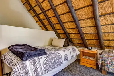 a bedroom with a bed and a wooden roof at Lavender Villa No loadshedding in Kempton Park
