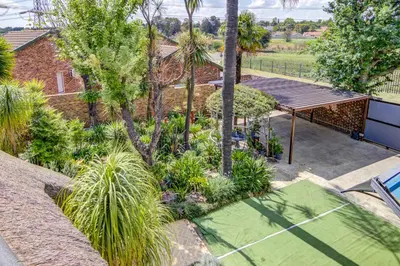 an aerial view of a garden with palm trees at Lavender Villa No loadshedding in Kempton Park