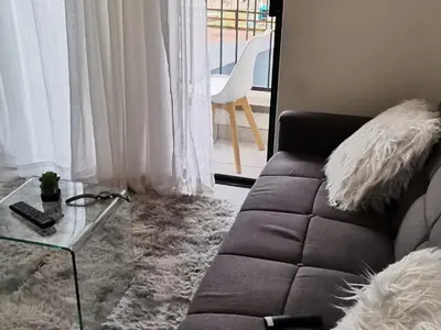 a living room with a couch and a glass table at The Blyde Crystal lagoon Pretoria in Pretoria