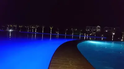 a swimming pool lit up blue at night at The Blyde Crystal lagoon Pretoria in Pretoria