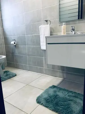 a bathroom with a sink and a mirror at The Blyde Crystal lagoon Pretoria in Pretoria