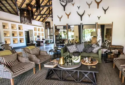 a living room with couches and a table at Abelana River Lodge in Phalaborwa