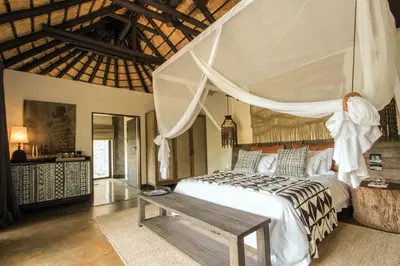 a bedroom with a large bed with a canopy at Abelana River Lodge in Phalaborwa