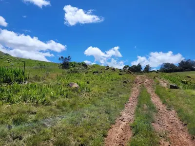 a dirt road in the middle of a field at Mountain View Farm Cottage 4X4 Vehicles ONLY in Dullstroom