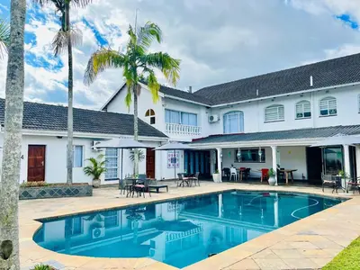 a swimming pool in front of a house at Wölfe Krantz Accommodation in Nelspruit