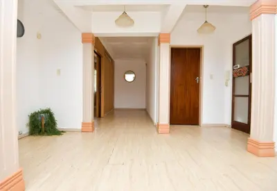 an empty hallway with white walls and a wooden door at Spacious Menlyn Maine Villa in Pretoria