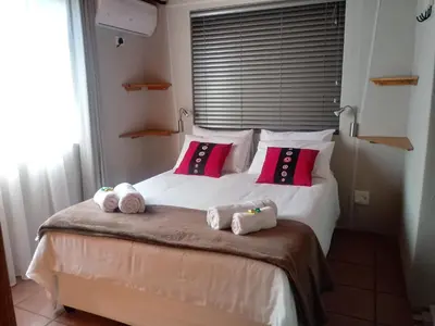 a bedroom with a bed with towels on it at Marloth Wild Fig in Marloth Park
