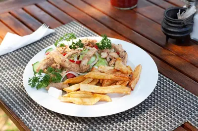 a plate of food with french fries on a table at Mziki Safari Lodge in Vaalkop Dam