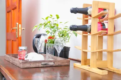 a table with glasses and a bottle of wine at Travetel OR Tambo Airport in Kempton Park