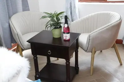 two chairs and a bottle of wine on a table at Travetel OR Tambo Airport in Kempton Park