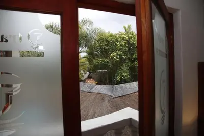 a door view of a garden through a glass door at Travetel OR Tambo Airport in Kempton Park