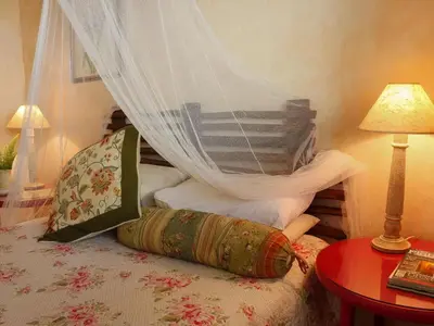 a bedroom with a bed with a canopy at Old Joe's Kaia in Schoemanskloof