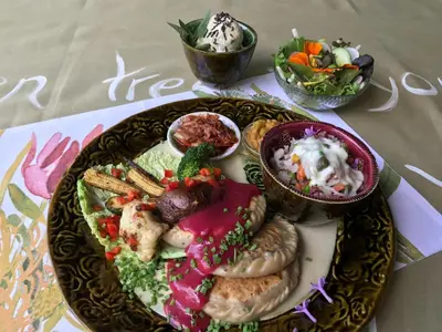 a plate of food on a table with bowls of food at Old Joe's Kaia in Schoemanskloof