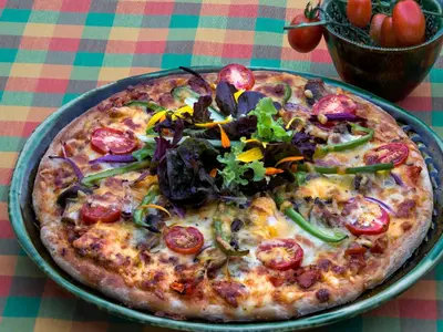 a pizza sitting on top of a table at Old Joe's Kaia in Schoemanskloof