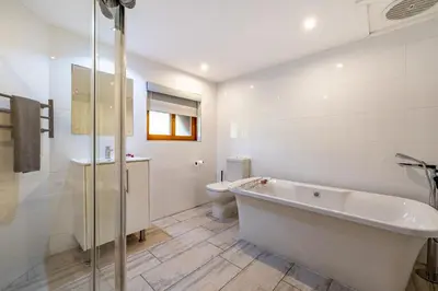 a white bathroom with a tub and a toilet at Kruger Park Lodge - IKZ2 - 3 Bedroom Chalet in Hazyview
