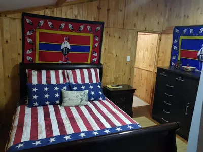 a bedroom with a bed with an american flag headboard at Good 2 Go Guest House in Benoni