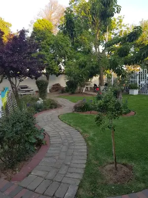 a walkway in a park with trees and grass at Good 2 Go Guest House in Benoni