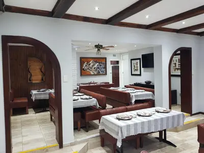 a restaurant with tables and chairs in a room at Good 2 Go Guest House in Benoni