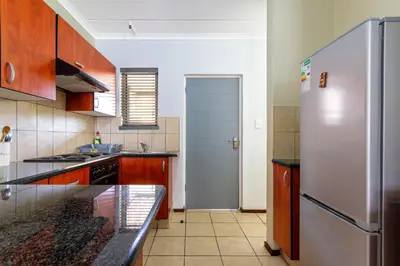a kitchen with a stainless steel refrigerator at 34 NOLE, 2 bed 2 bath apartment in Midrand