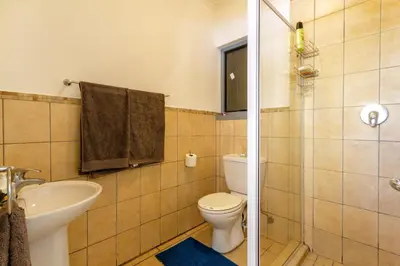 a bathroom with a toilet and a sink at 34 NOLE, 2 bed 2 bath apartment in Midrand