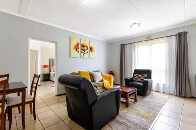 a living room with two chairs and a table at 34 NOLE, 2 bed 2 bath apartment in Midrand