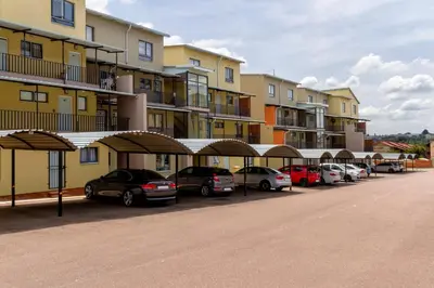 a row of cars parked in front of a building at 34 NOLE, 2 bed 2 bath apartment in Midrand