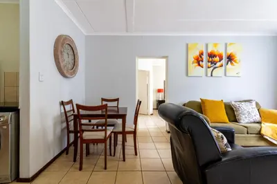 a living room with a couch and a table at 34 NOLE, 2 bed 2 bath apartment in Midrand