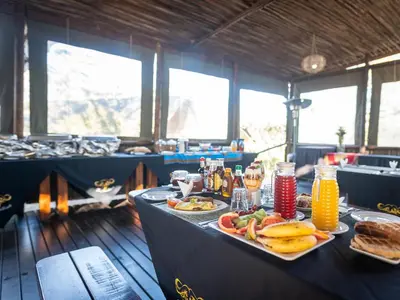a table with plates of food and drinks on it at Buffalo Rock Tented Camp in Hazyview