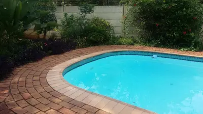 a small swimming pool in a brick yard at Chariots Guest House in Polokwane